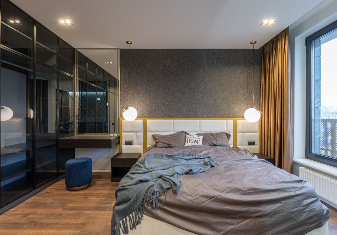 Dark marble-pattern wallpaper behind a bed